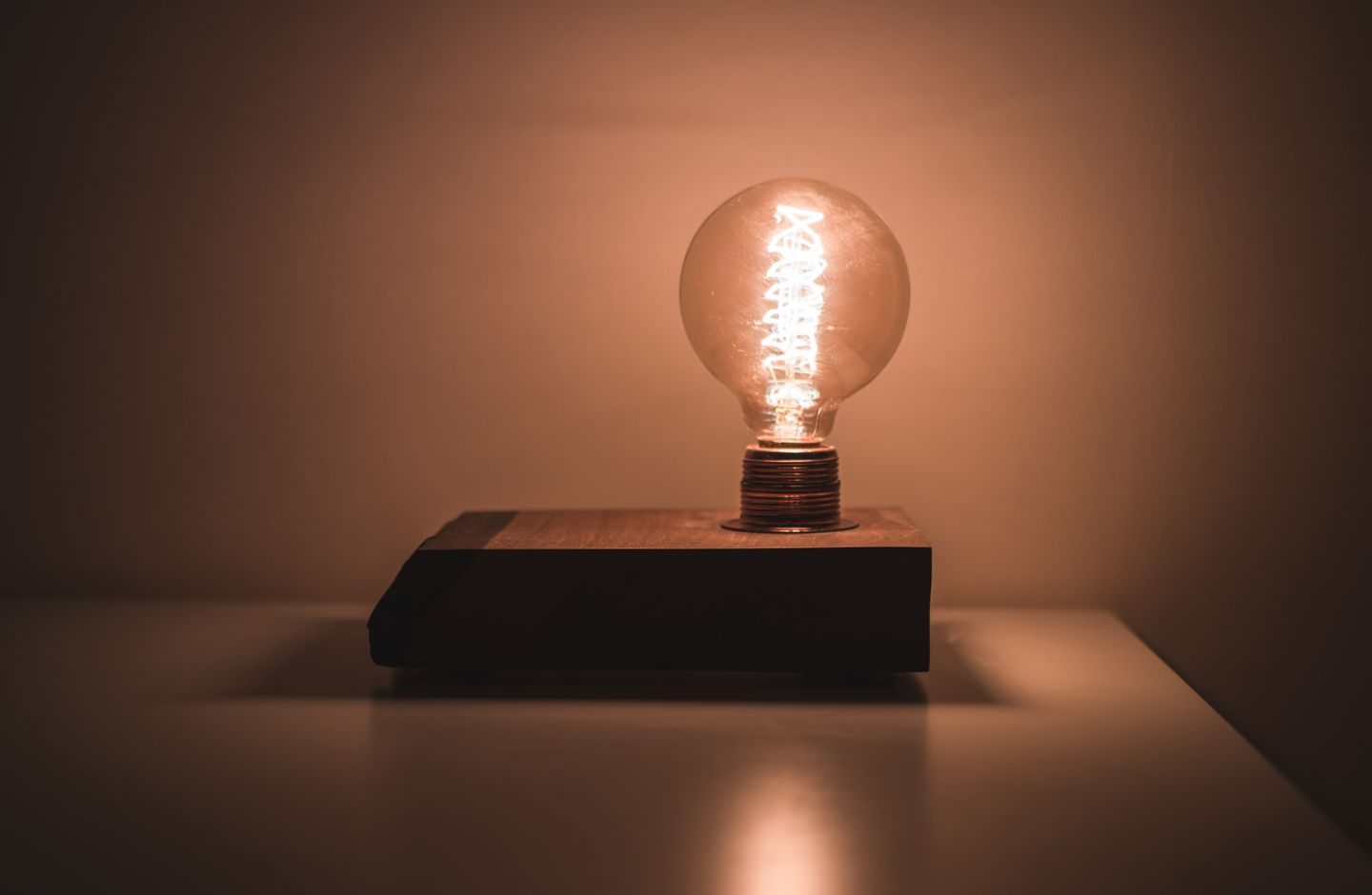 A single lightbulb glowing warmly, symbolizing the moment an answer clicks.