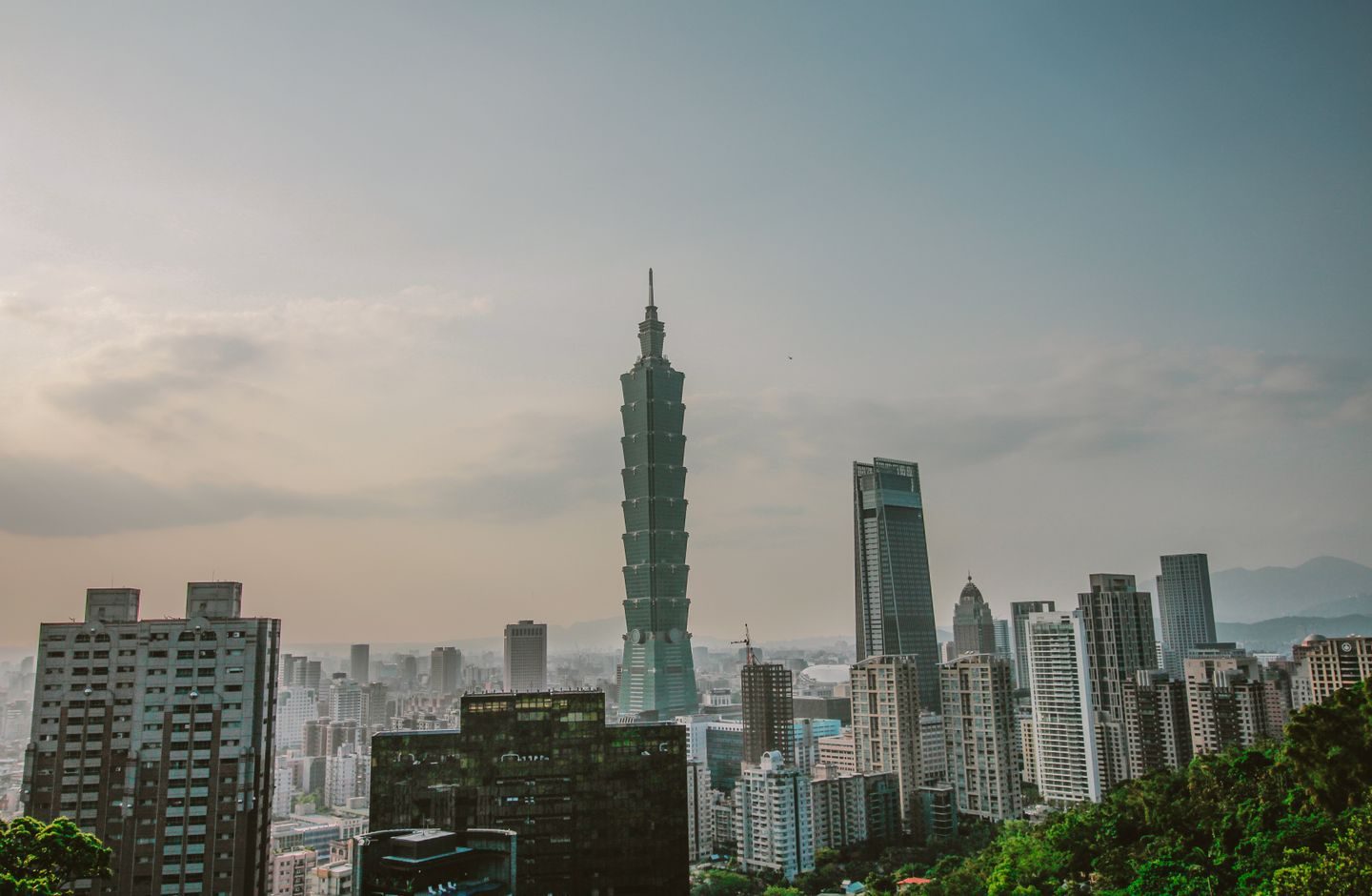Daytime view of Taipei's high-rise skyline, with Taipei 101 among the buildings.