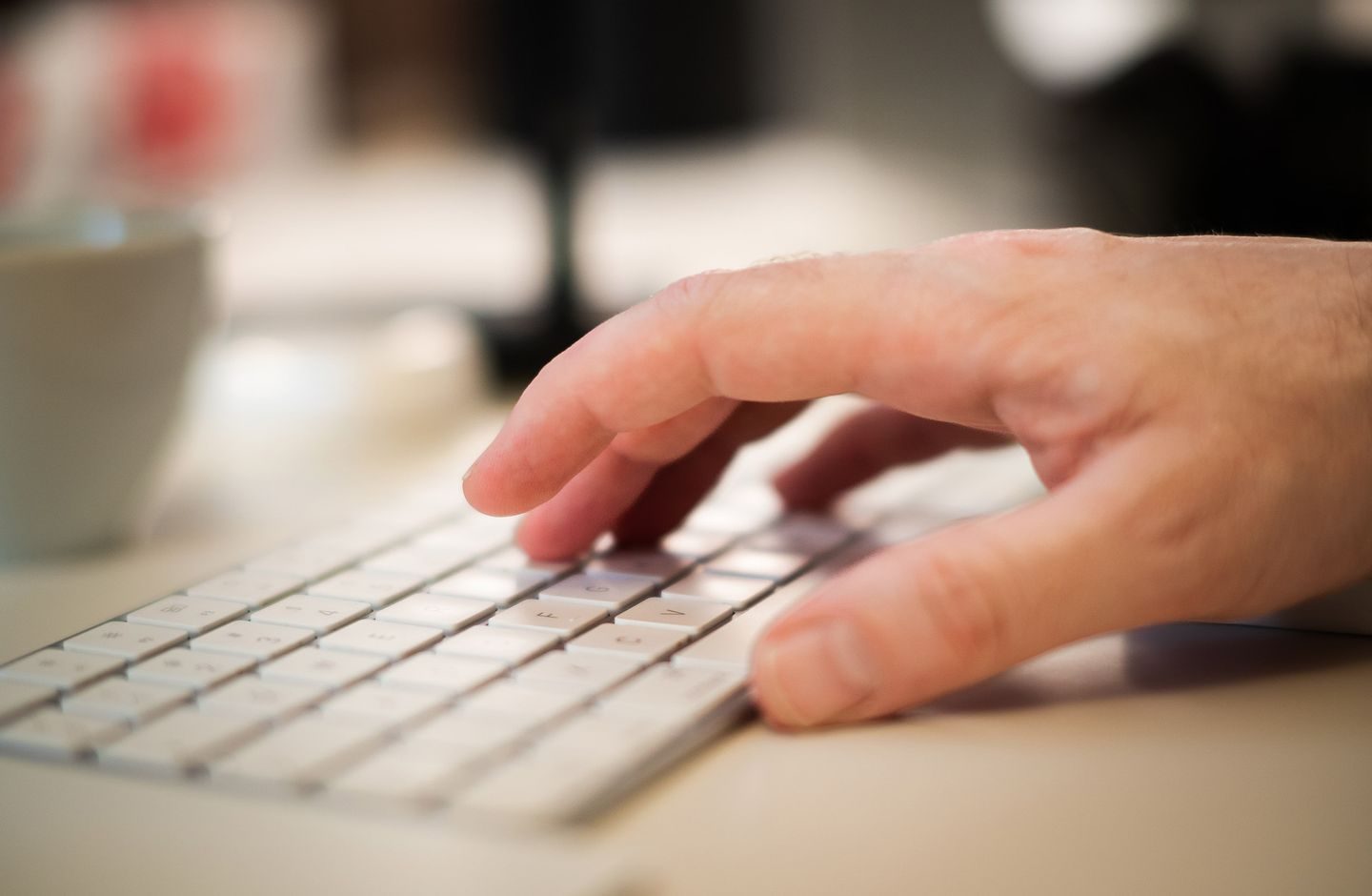 Close-up of hands typing on a keyboard.